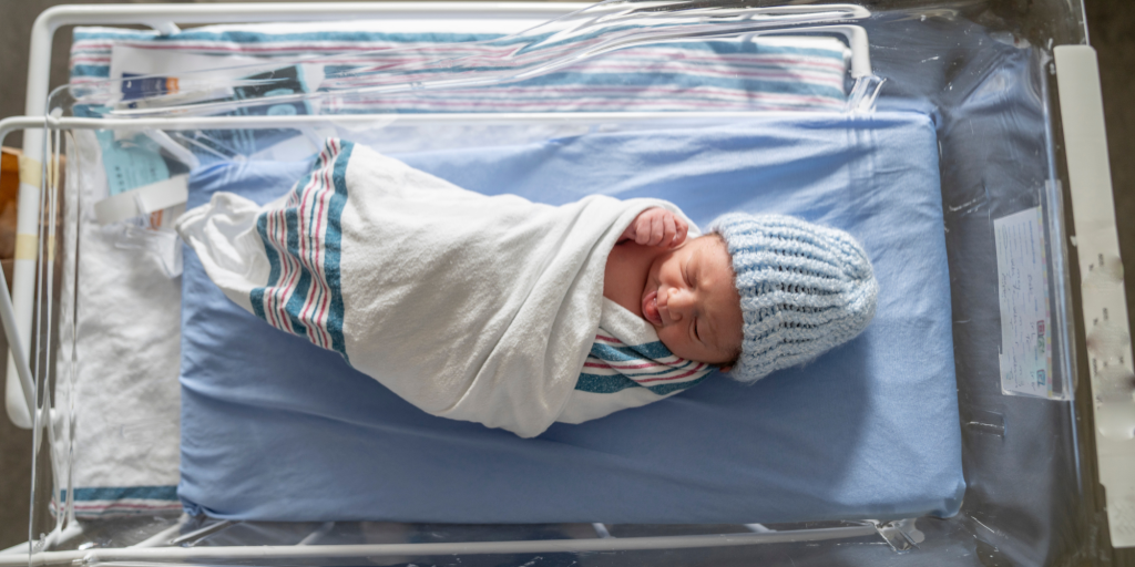 newborn baby in bassinet