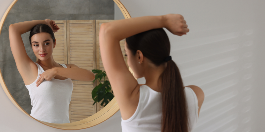 woman performing self-breast exam